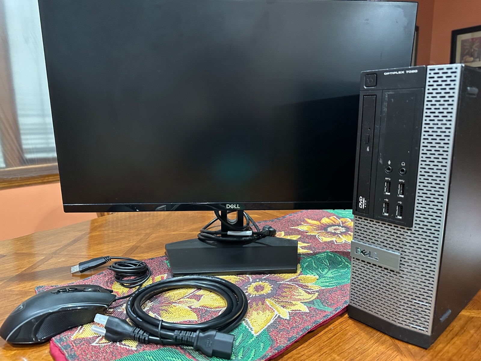 Dell Optiplex black, personal computer with 60 Hz monitor and wired mouse.